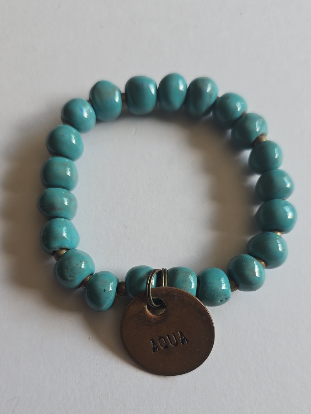 Aqua Turquoise Colored Stretch Bead Bracelet with Branded Charm